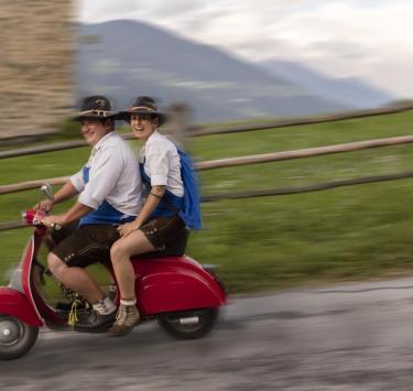Two people on a Vespa